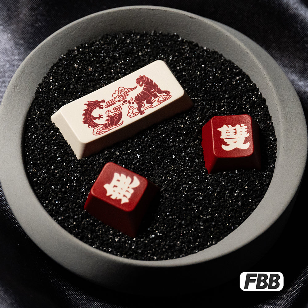 Three accent keycaps in a bowl: white and red caps with Chinese characters