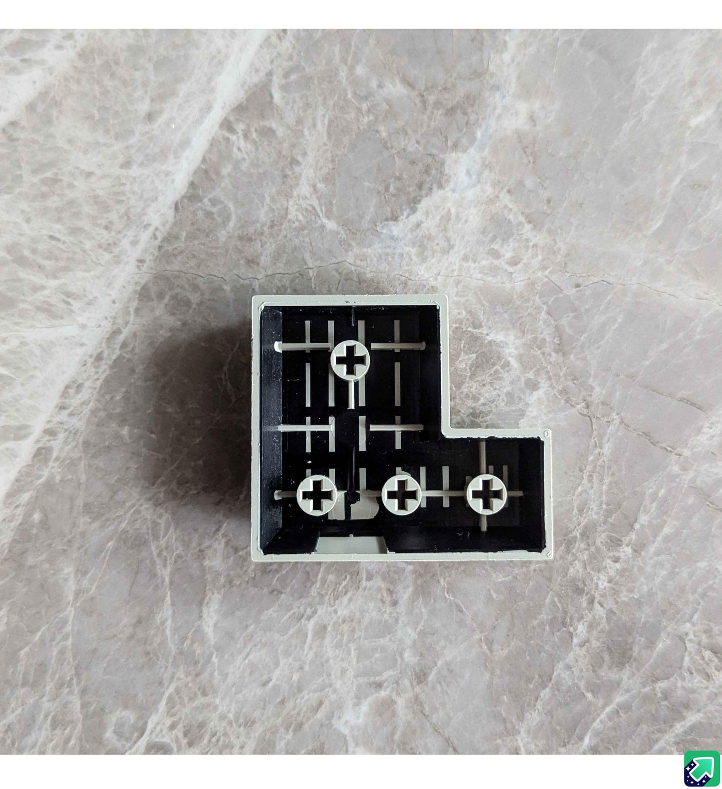 Black keyboard keycap piece with plus symbols and cross-shaped cutouts