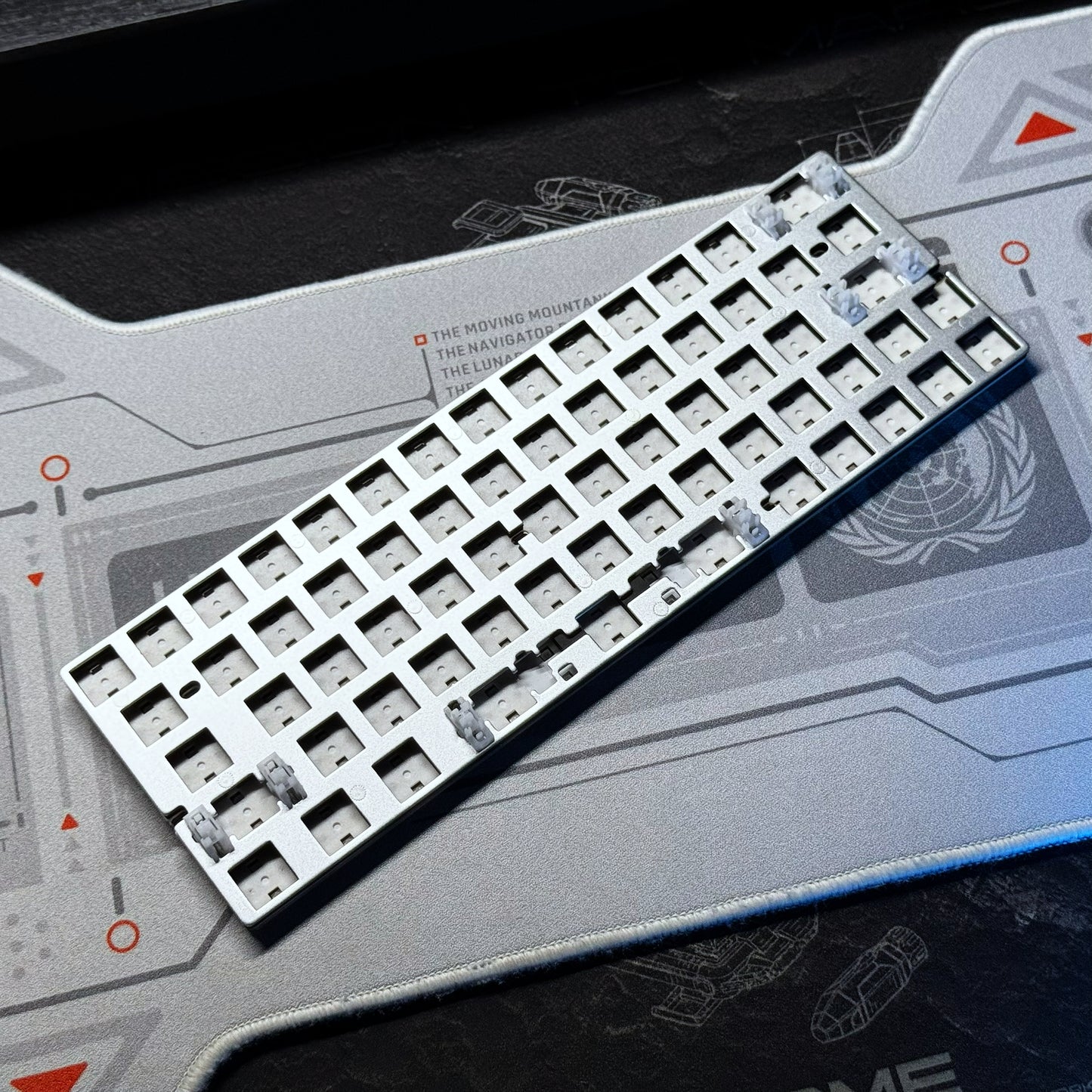PCB module with long row of white switch sockets on a gray circuit board
