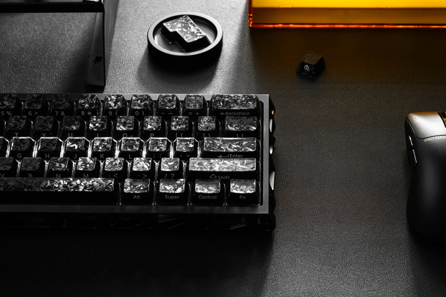 Black mechanical keyboard with carbon-textured keycaps and labeled rows