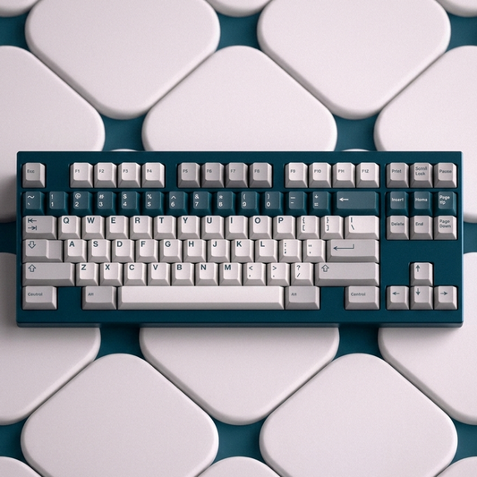 Keycap set in white and teal with gray modifier keys, arranged on a keyboard tray.