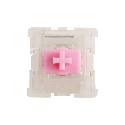 Keyboard switch view with pink cross-shaped actuator in clear housing