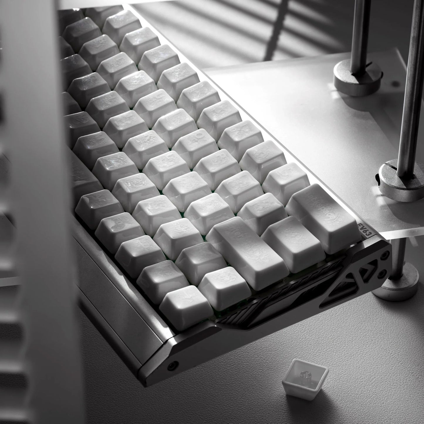 White keyboard keycaps with crazed ceramic glaze on a tray