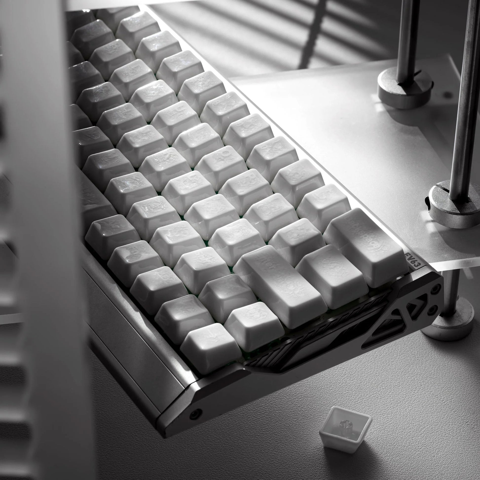 White keyboard keycaps with crazed ceramic glaze on a tray