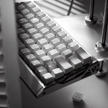 White keyboard keycaps with crazed ceramic glaze on a tray