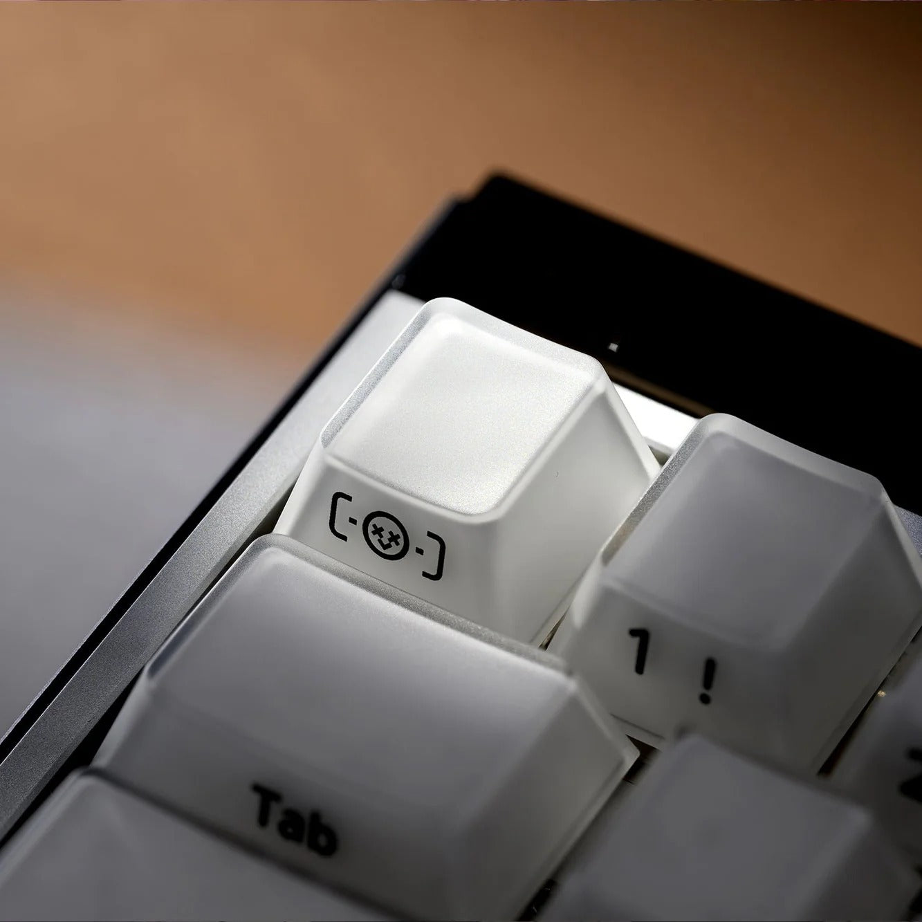 Close-up of white keyboard keys showing Tab and key symbols on a black base