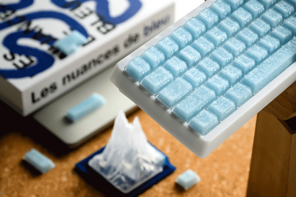 Light blue mechanical keyboard keycaps with glossy, cube-like texture