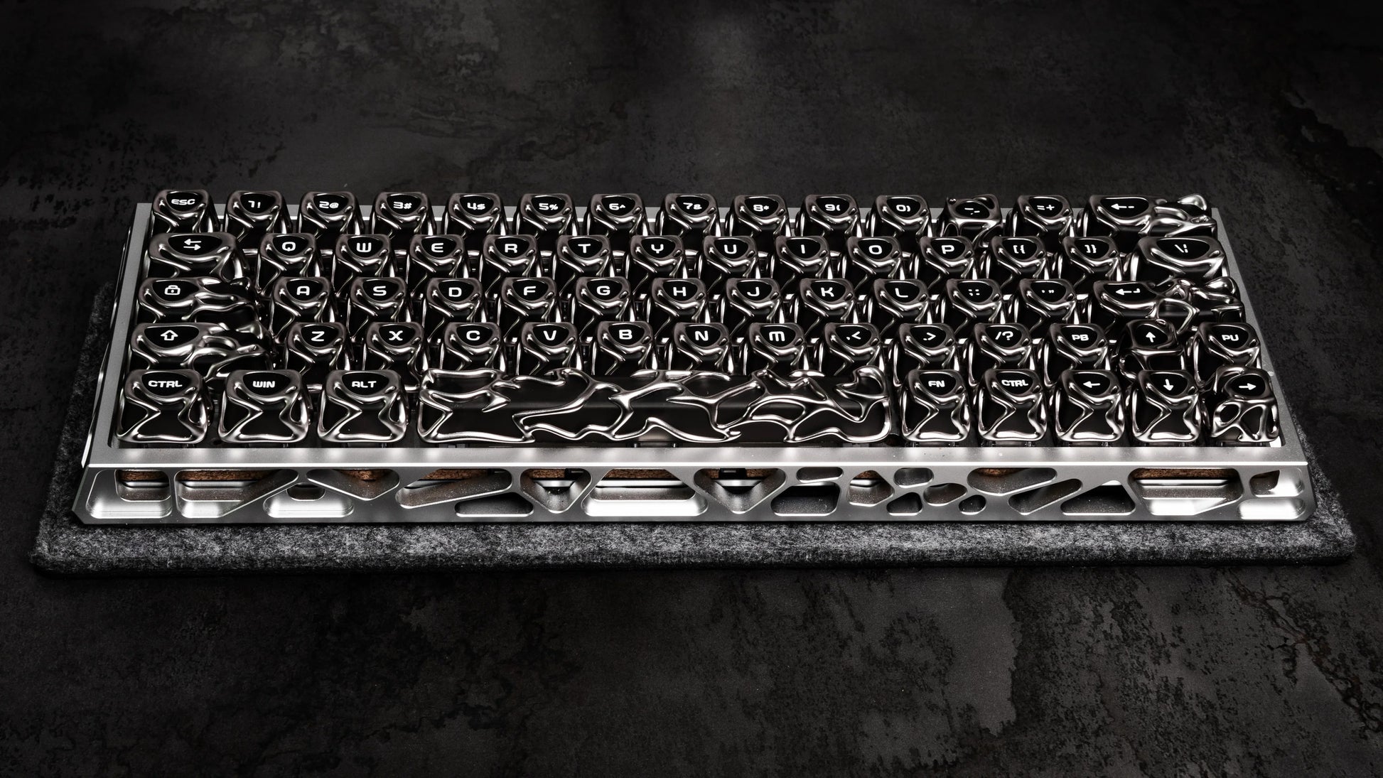 Full keyboard keycap layout in glossy black and silver, on textured pad