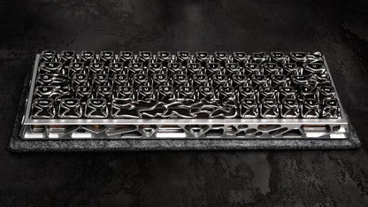 Full keyboard keycap layout in glossy black and silver, on textured pad