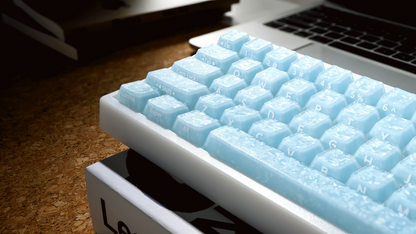 Blue mechanical keyboard keycaps on a white base, close-up