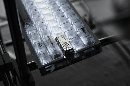 Keycap tray with light and dark engraved keycaps in individual square slots