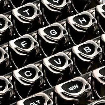 Close-up of glossy black and silver keycaps with letter legends