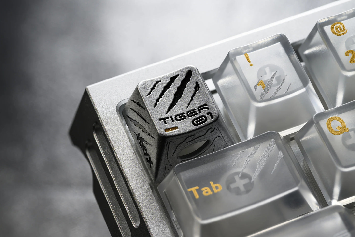 Keycap insert with tiger-themed engraving and Tab keycap in a metal tray
