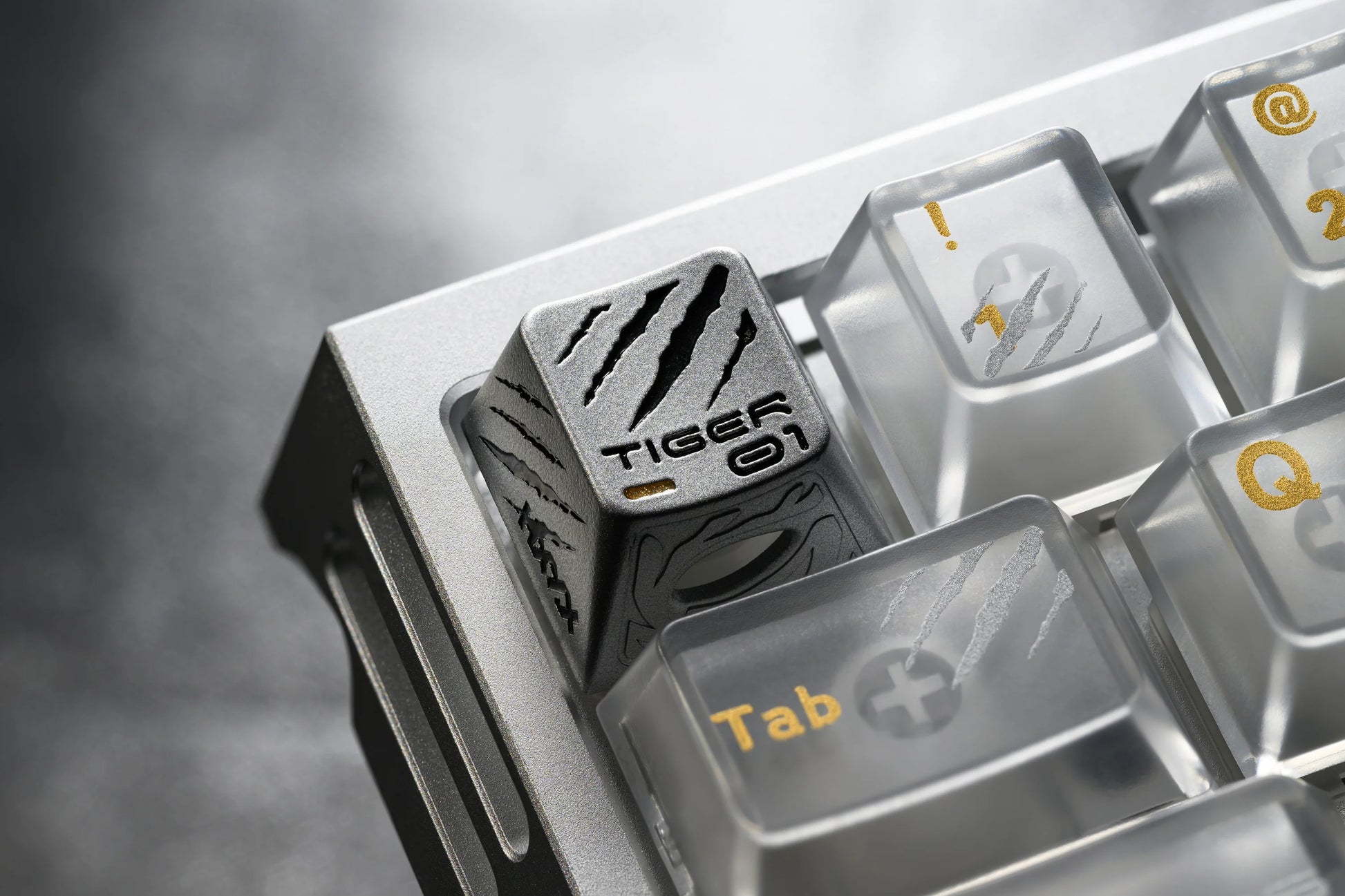 Keycap insert with tiger-themed engraving and Tab keycap in a metal tray
