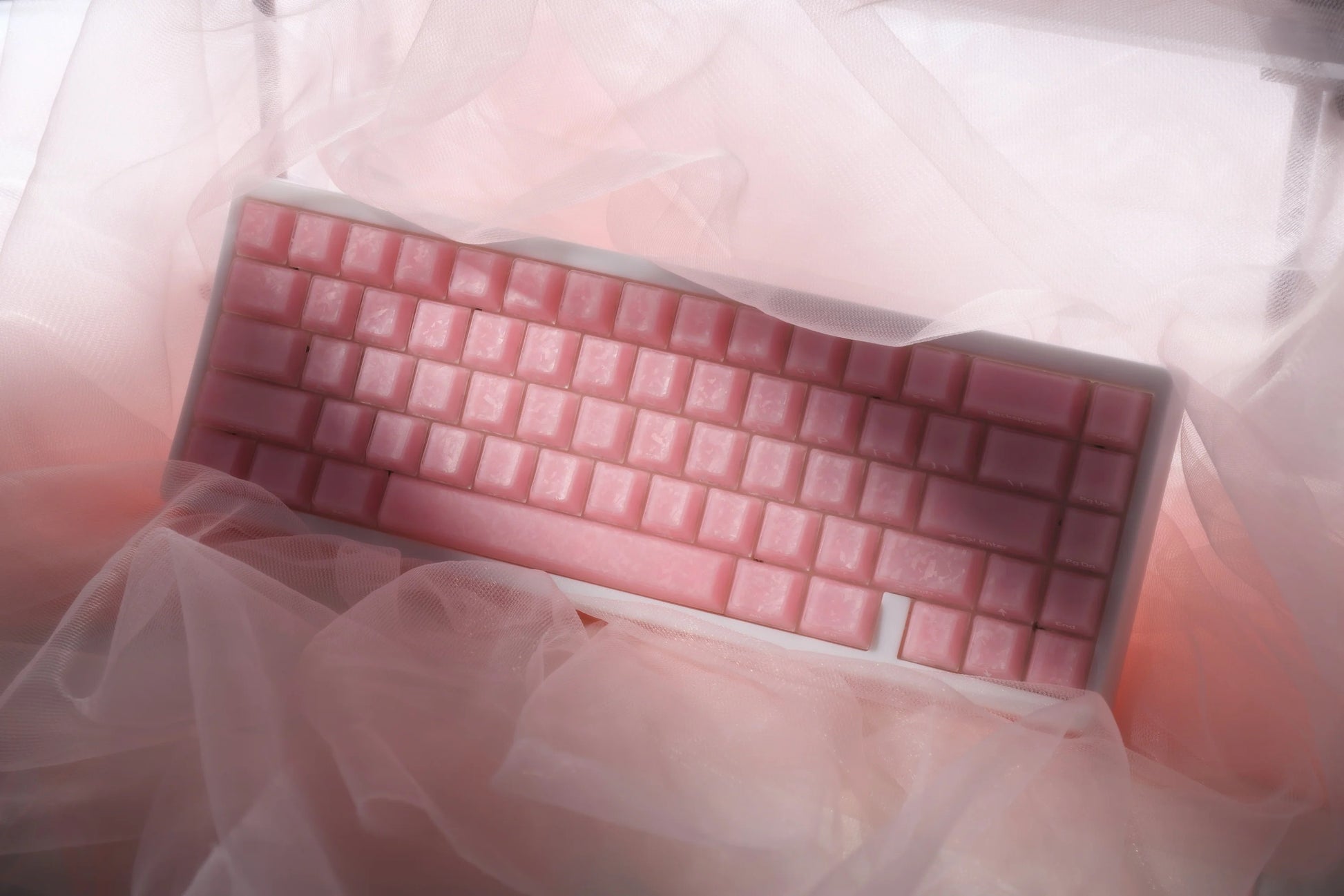 Pink mechanical keyboard keycaps in a rectangular protective sleeve