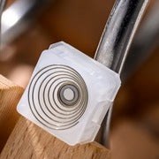 Whisper silent switch with white circular housing and metal stem, close-up