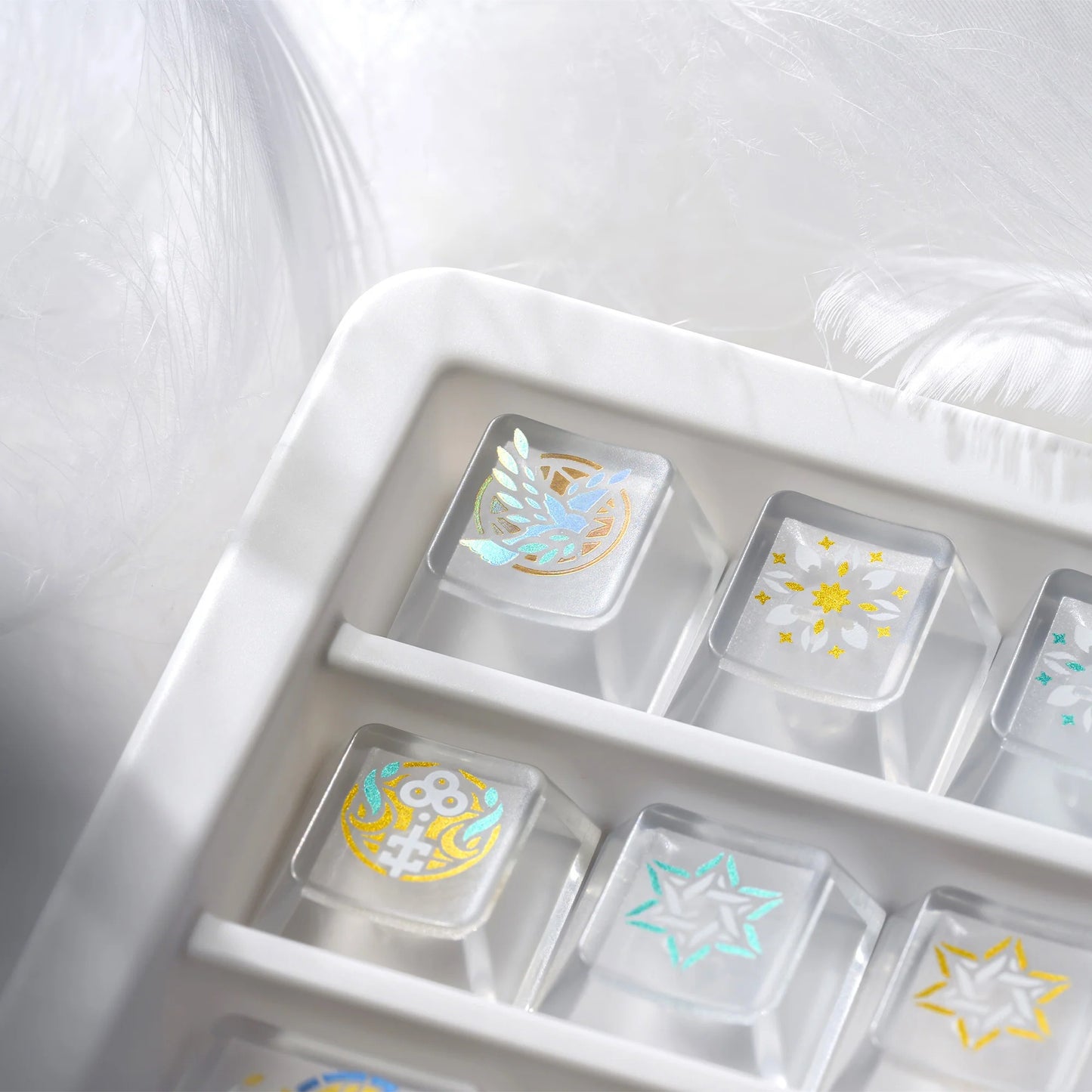 Clear organizer tray with gold and white stained-glass style keycaps and decorative icons