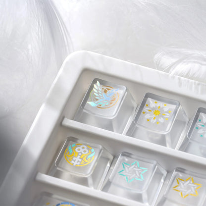 Clear organizer tray with gold and white stained-glass style keycaps and decorative icons