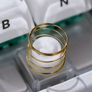 Silent switch assembly with transparent base and gold coil spring, close-up