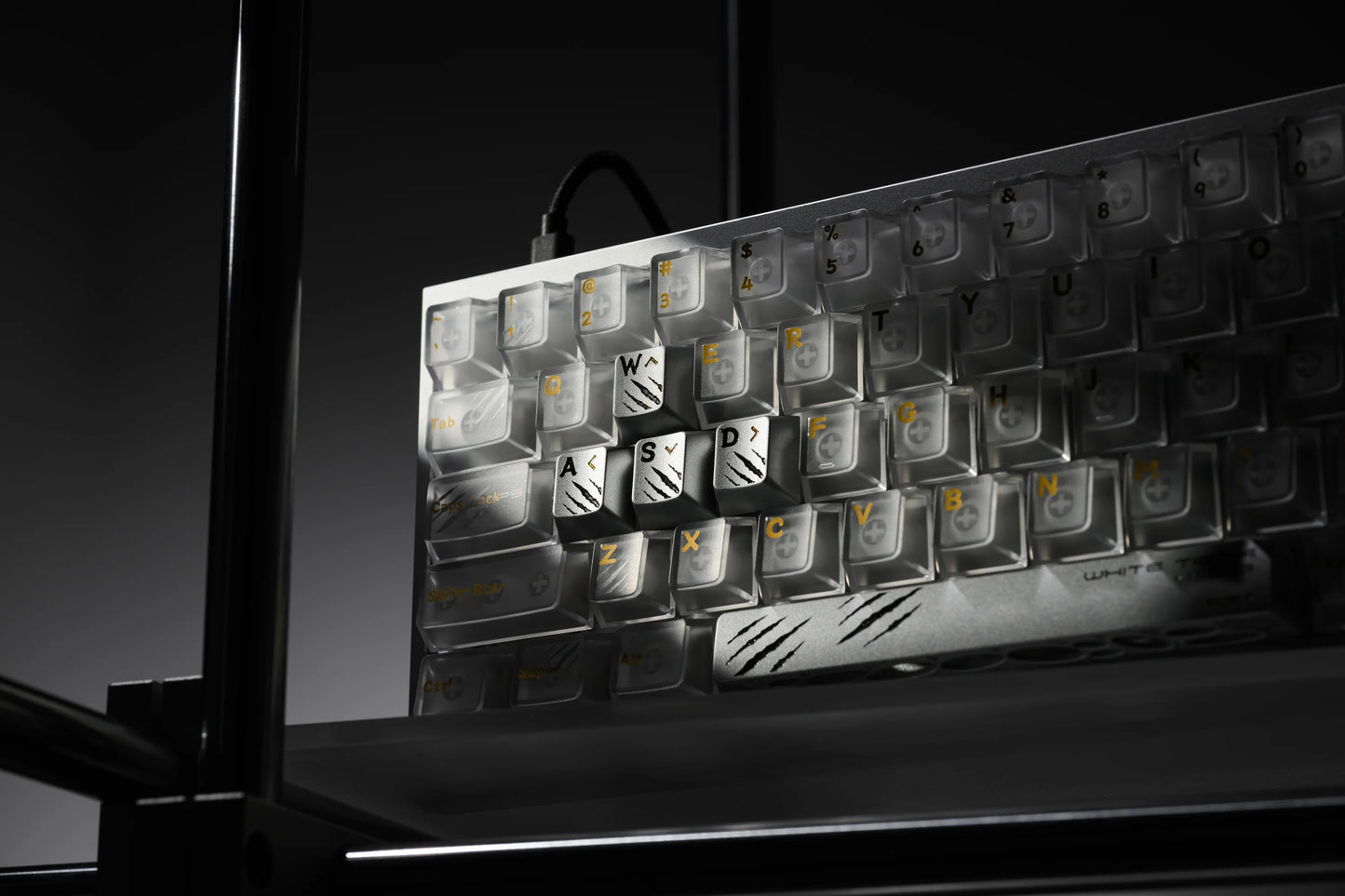 Keycap tray angled view with light and dark keycaps and a tiger icon key