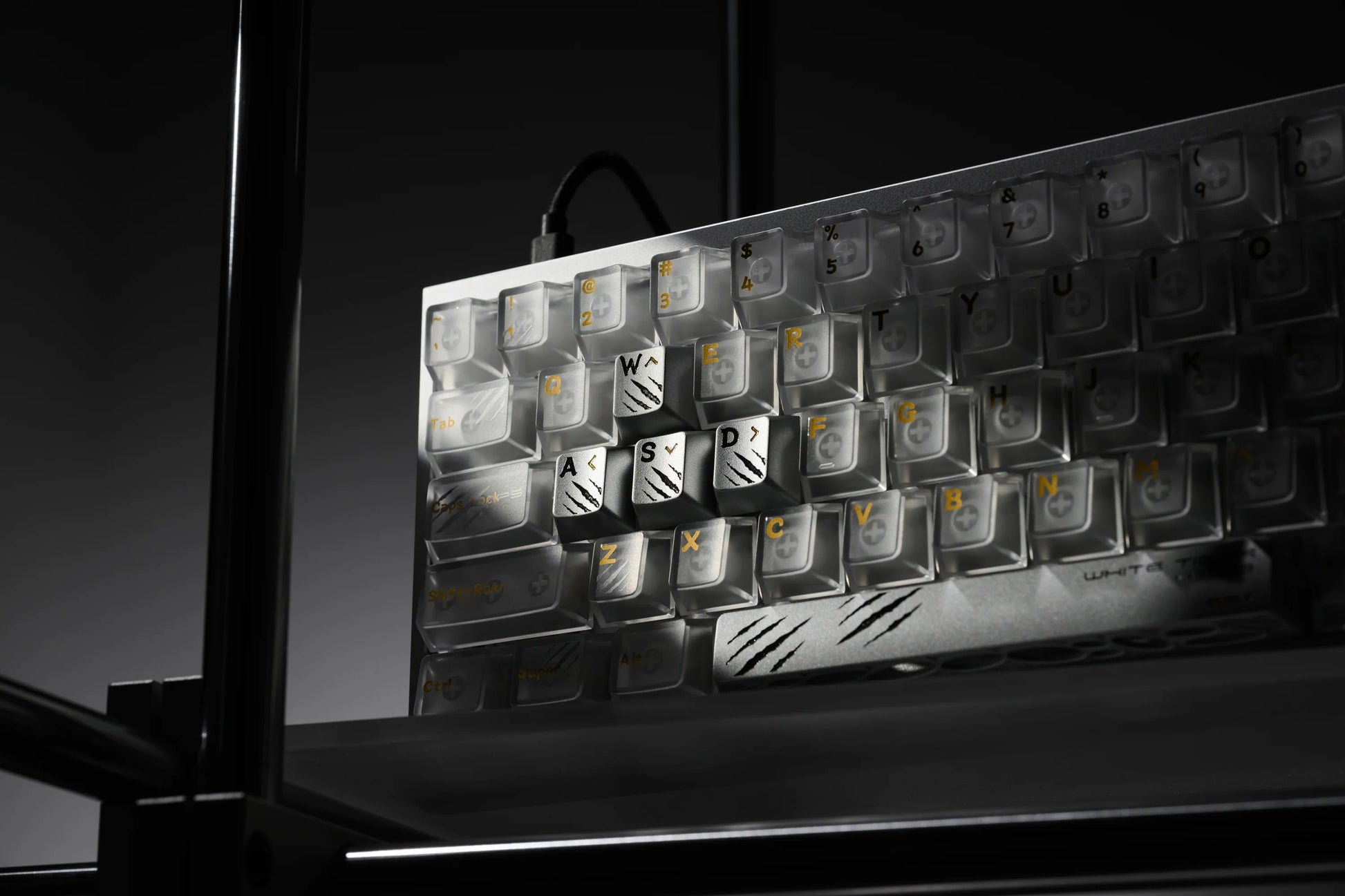Keycap tray angled view with light and dark keycaps and a tiger icon key