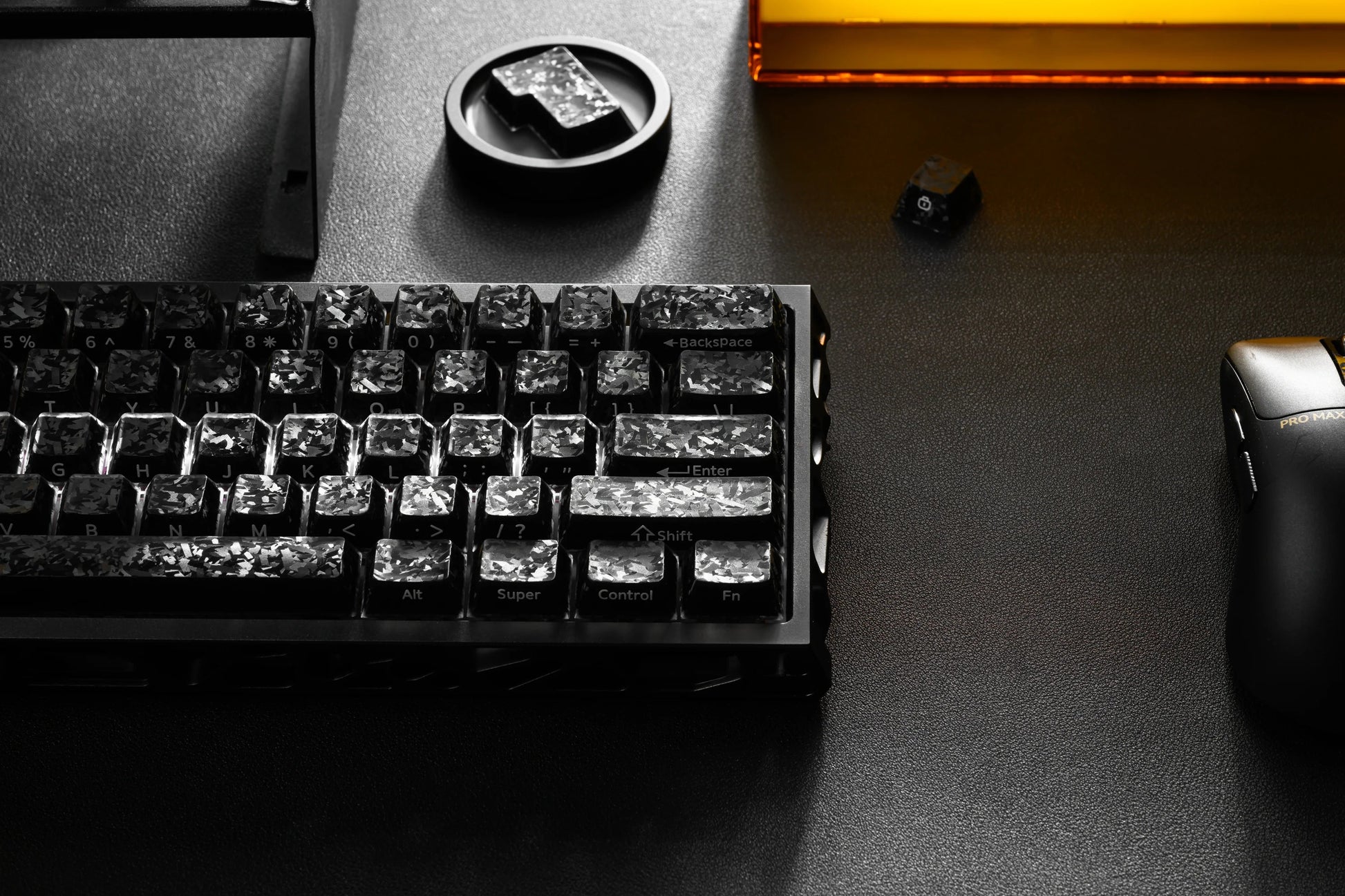 Black mechanical keyboard with carbon-textured keycaps and labeled rows