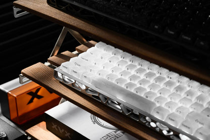 White mechanical keyboard keycaps on a wooden base with legends visible