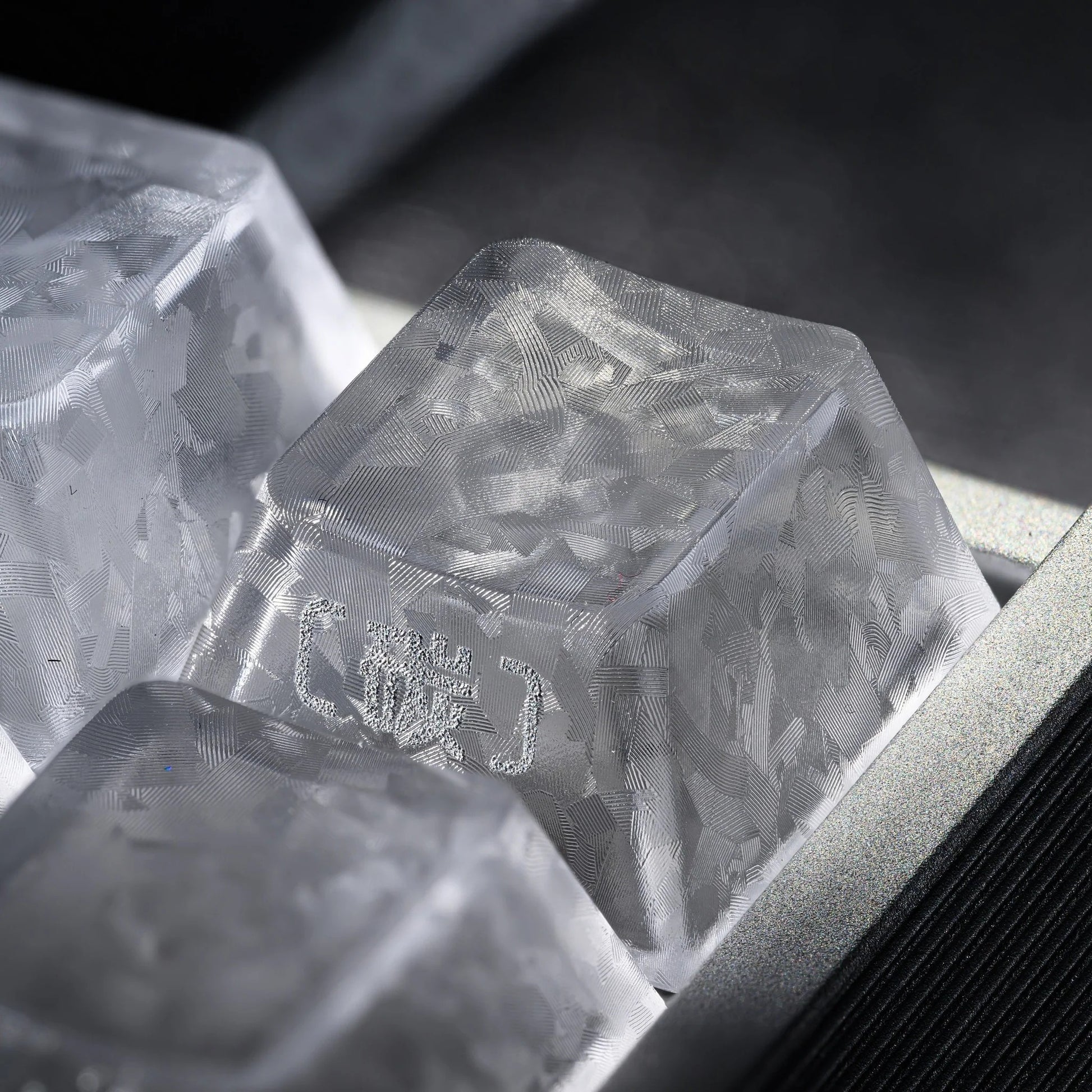 Clear translucent keycap with textured pattern and embossed legend