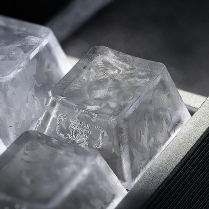 Clear translucent keycap with textured pattern and embossed legend