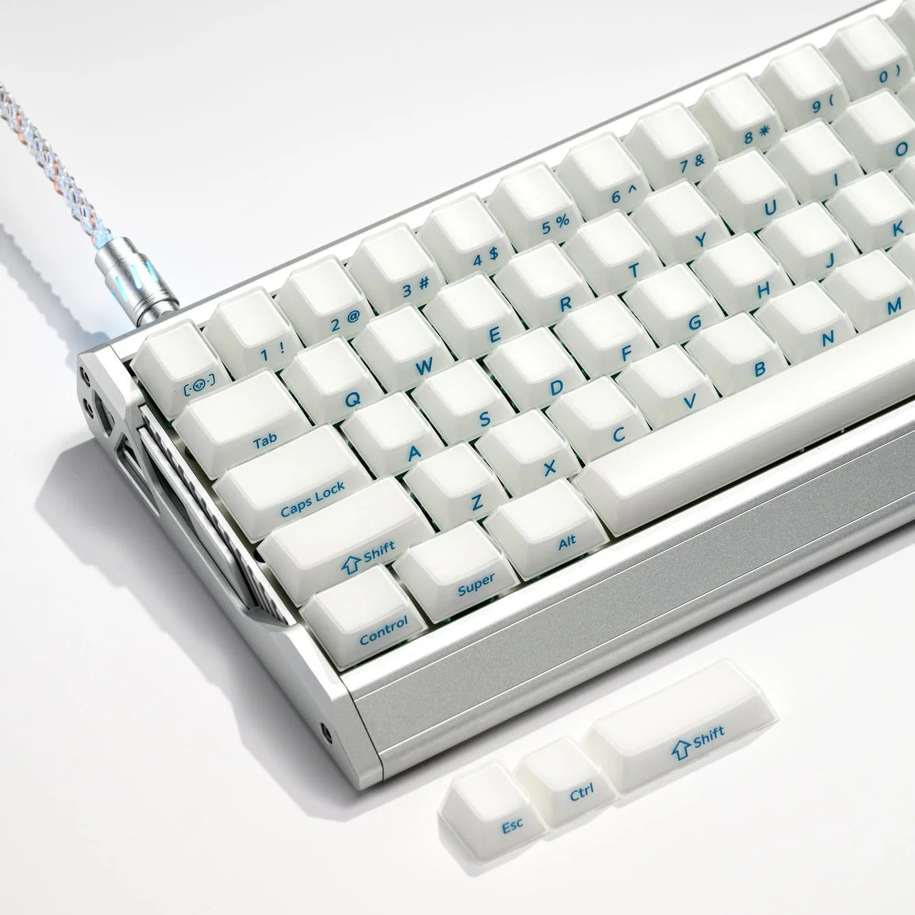 Mechanical keyboard showing white keycaps, including Tab, Caps Lock, and arrow keys