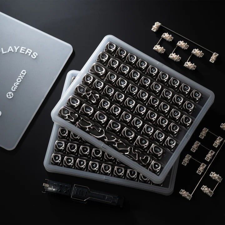 Keycap set organizer case showing black and silver keycaps and switch pullers
