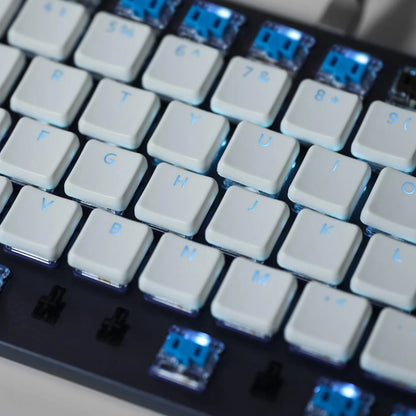 Translucent keycap set with white legends and blue accents, staggered layout