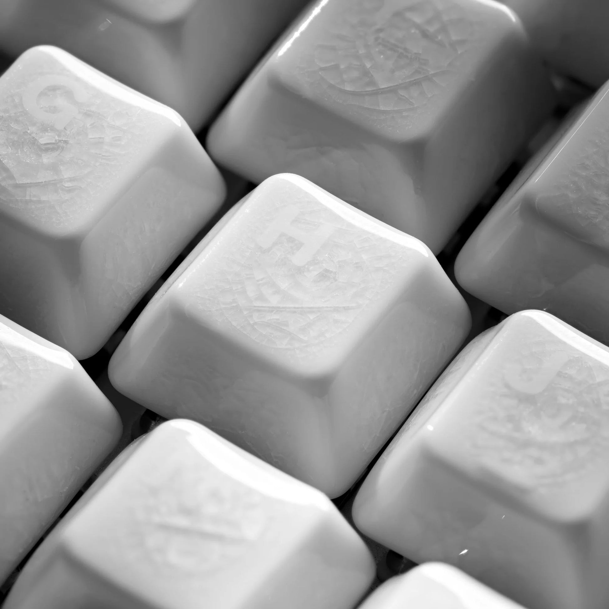 Close-up of white square keycaps with crazed ceramic texture