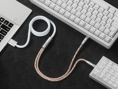 Braided USB split cable with two connectors, laid across keyboard