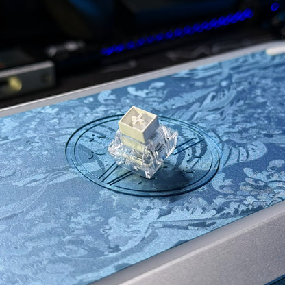 Hall-effect keyboard switch mounted on blue textured surface, clear housing